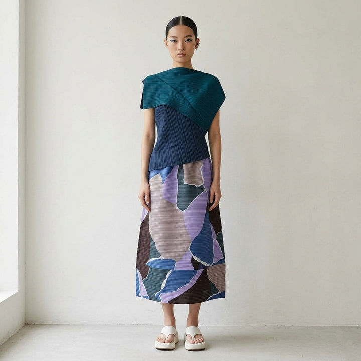 Pleats Please Issey Miyake SURPRISE! Flared Skirt in abstract patchwork print featuring blue, lavender, teal, taupe, and black tones on micro-pleated fabric with elasticated drawstring waist - lifestyle