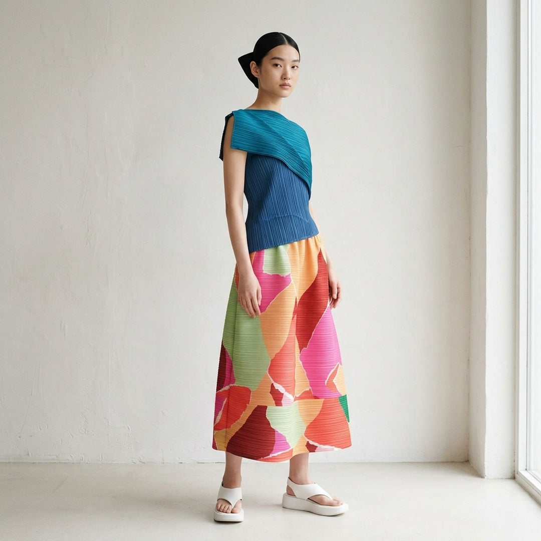 Pleats Please Issey Miyake SURPRISE! Flared Skirt in abstract patchwork print featuring blue, lavender, teal, taupe, and black tones on micro-pleated fabric with elasticated drawstring waist - lifestyle