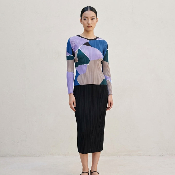 Pleats Please Issey Miyake SURPRISE! long sleeve round-neck top featuring permanent pleating and an abstract multicolour print in lavender, cobalt blue, teal, taupe, and black - lifestyle