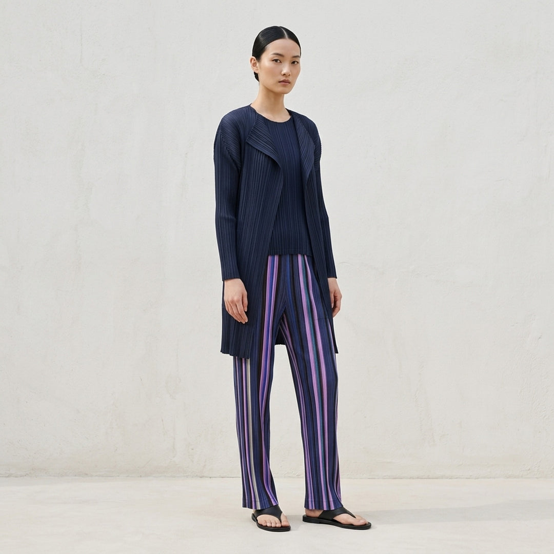 Pleats Please Issey Miyake TAPE TAPE Pants featuring multicolour vertical stripes in tangerine, fuchsia, violet, coral, and sky blue with a cropped flared silhouette and elasticated waistband - lifestyle