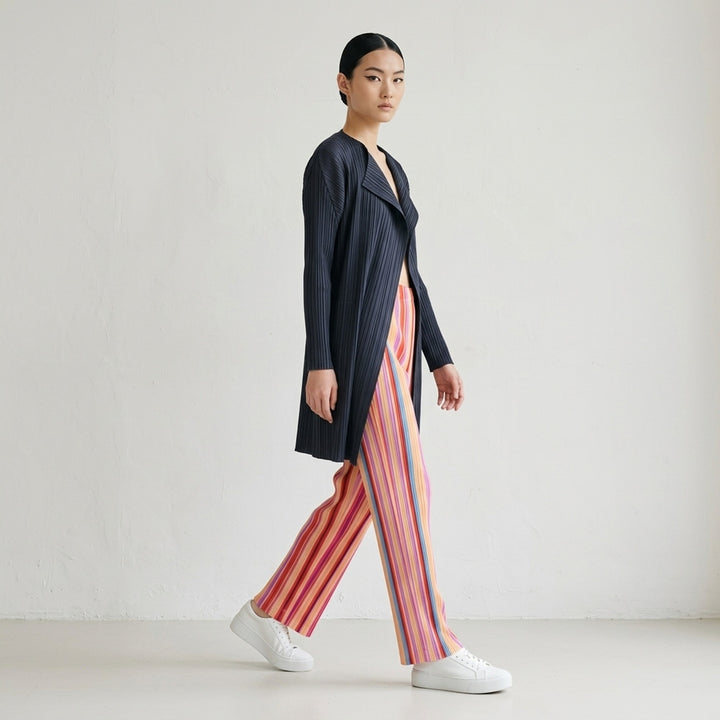 Pleats Please Issey Miyake TAPE TAPE Pants featuring multicolour vertical stripes in tangerine, fuchsia, violet, coral, and sky blue with a cropped flared silhouette and elasticated waistband - lifestyle