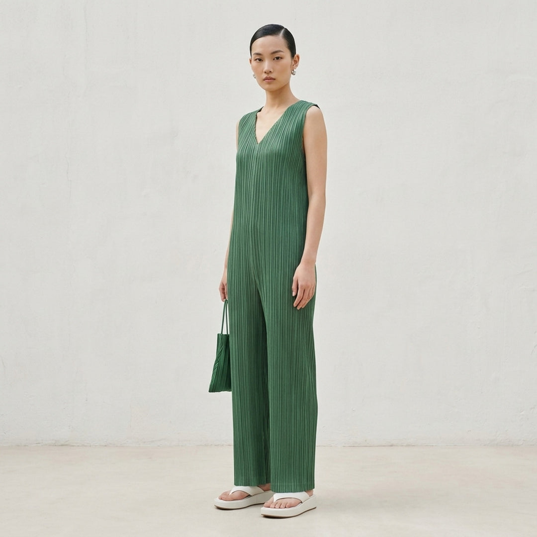 Pleats Please Issey Miyake Thicker Bottoms 2 Jumpsuit in charcoal, featuring a sleeveless V-neck with tonal lace trim, permanent-pleat fabric, and a relaxed wide-leg silhouette - lifestyle