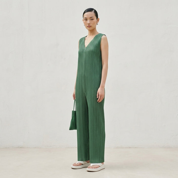 Pleats Please Issey Miyake Thicker Bottoms 2 Jumpsuit in charcoal, featuring a sleeveless V-neck with tonal lace trim, permanent-pleat fabric, and a relaxed wide-leg silhouette - lifestyle