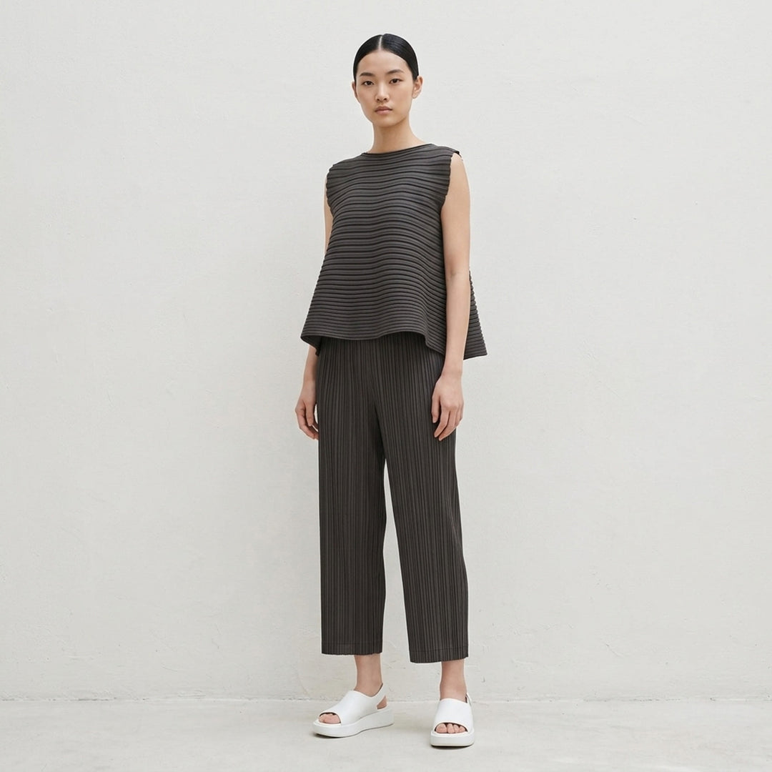 Pleats Please Issey Miyake Thicker Bottoms 2 wide-leg pleated culottes in charcoal with elasticated waistband and accordion micro-pleat construction - lifestyle