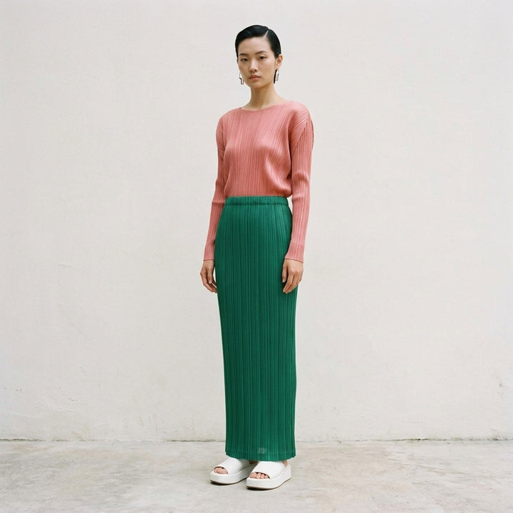 Pleats Please Issey Miyake Thicker Bottoms pleated midi skirt in taupe, featuring all-over vertical pleating and an elasticated waistband, displayed flat against a white background - lifestyle