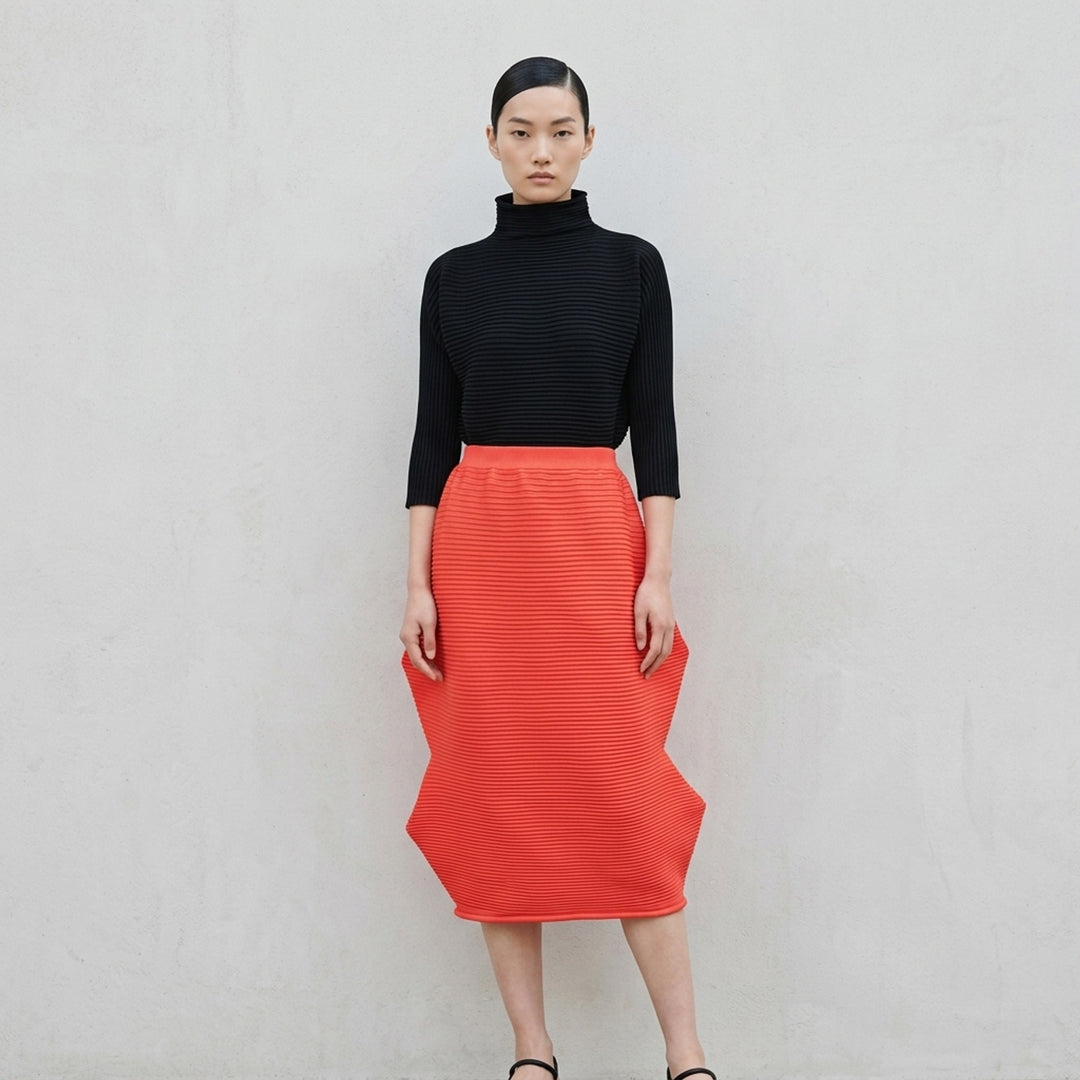 Pleats Please Issey Miyake Zig Zag Knit Skirt in black, shown flat with structural wave-shaped ribbed knit silhouette and elasticated waistband - lifestyle