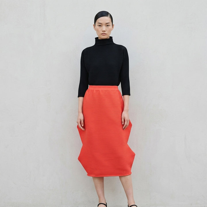 Pleats Please Issey Miyake Zig Zag Knit Skirt in black, shown flat with structural wave-shaped ribbed knit silhouette and elasticated waistband - lifestyle