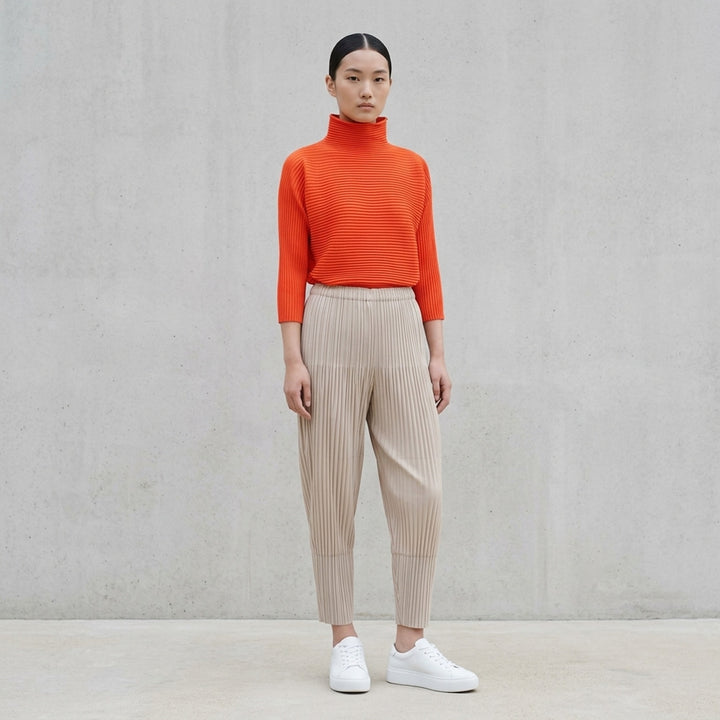Pleats Please Issey Miyake Zig Zag Knit in black — front view showing horizontal ribbed pleating, foldover turtleneck, wide three-quarter sleeves, and boxy silhouette - lifestyle