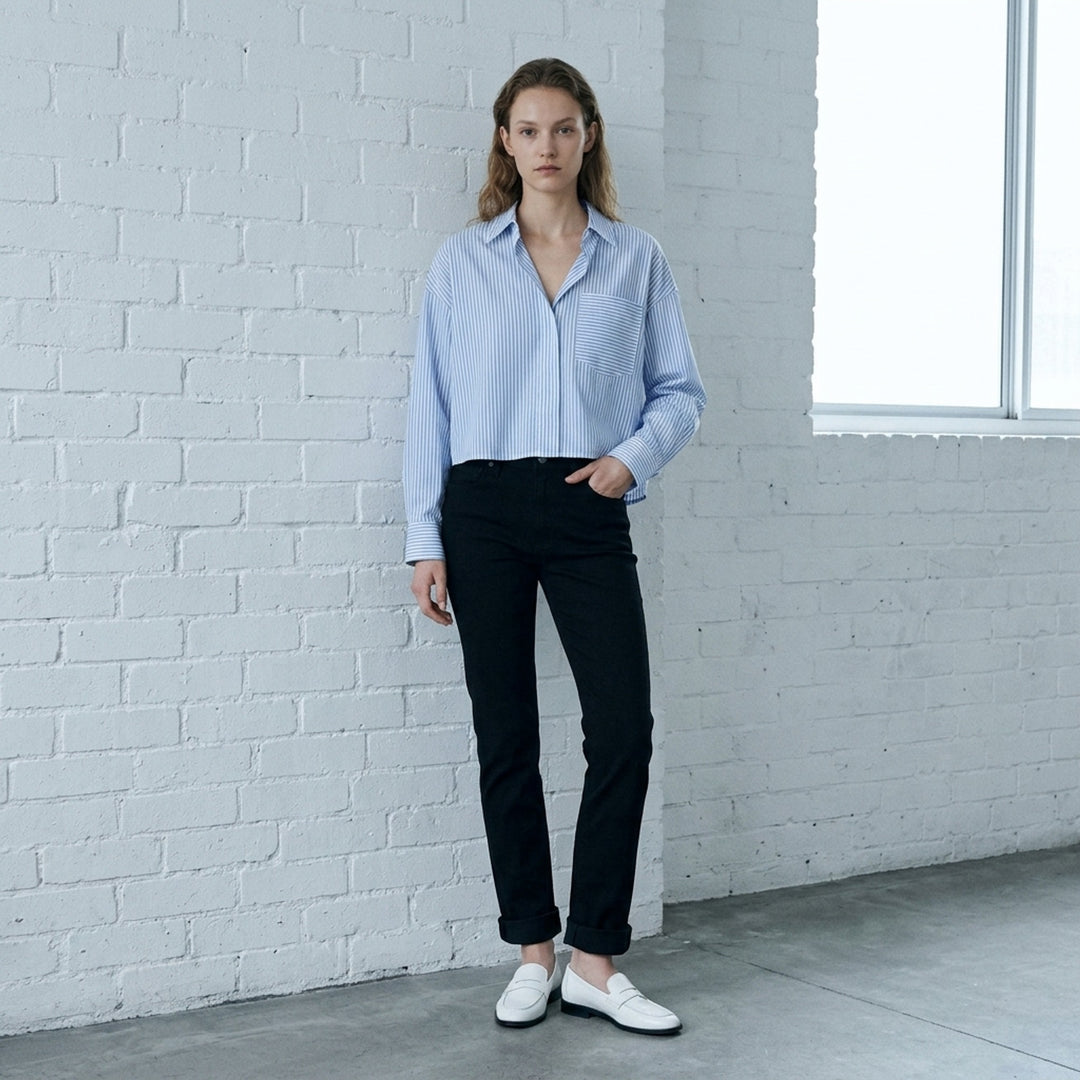 rag & bone Flexi Wren mid-rise full slim jeans in black stretch denim with five-pocket styling and rolled cuffs, shown from the front - lifestyle