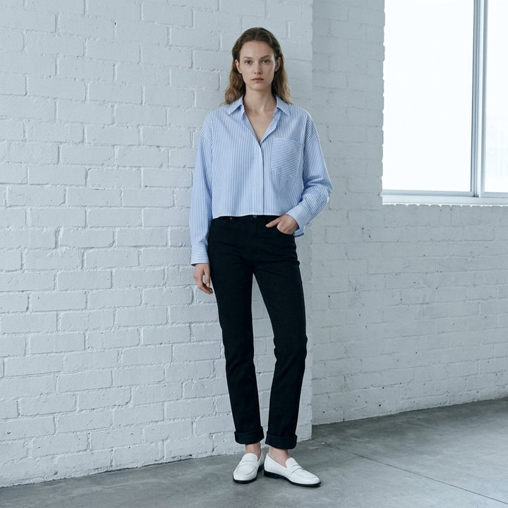 rag & bone Flexi Wren mid-rise full slim jeans in black stretch denim with five-pocket styling and rolled cuffs, shown from the front - lifestyle
