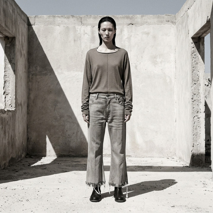 Rick Owens Bolan Cut cropped flare jeans in washed grey denim with heavily frayed raw hem and five-pocket construction, front view - lifestyle