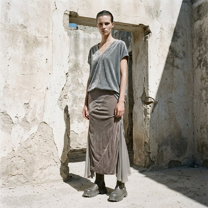 Rick Owens Double Sliced Midi Skirt in taupe crushed velvet with diagonal seaming and fluid chiffon hem panels, front view on white background - lifestyle