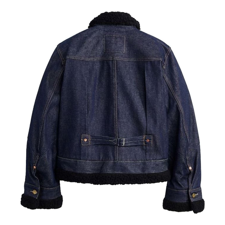 sacai x Levi's women's indigo denim trucker jacket with cream sherpa collar, cuffs and hem, leather patch pocket and buckled side straps - packshot