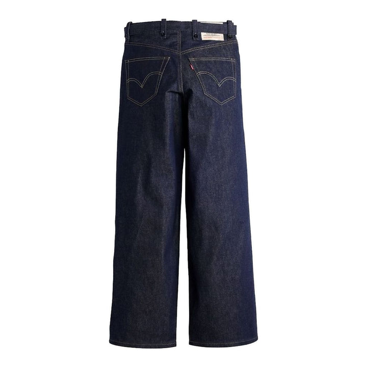 sacai wide-leg washed blue jeans with layered waistband and black belt with metal buckle, shown from the front - packshot
