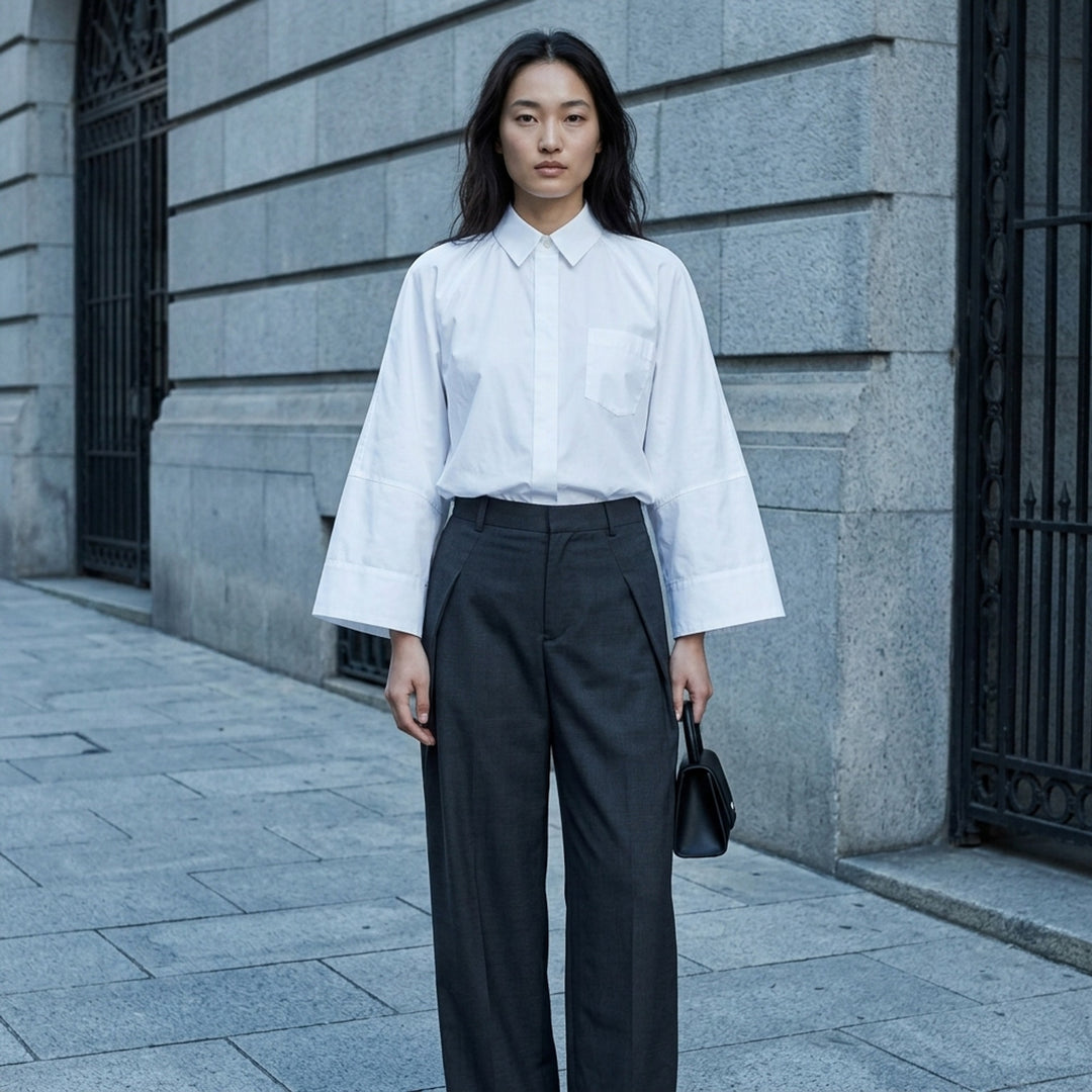 sacai Wide Sleeve Poplin Shirt in black, featuring a concealed button placket, point collar, flared long sleeves with deep cuffs, a chest patch pocket, and twin lower patch pockets - lifestyle