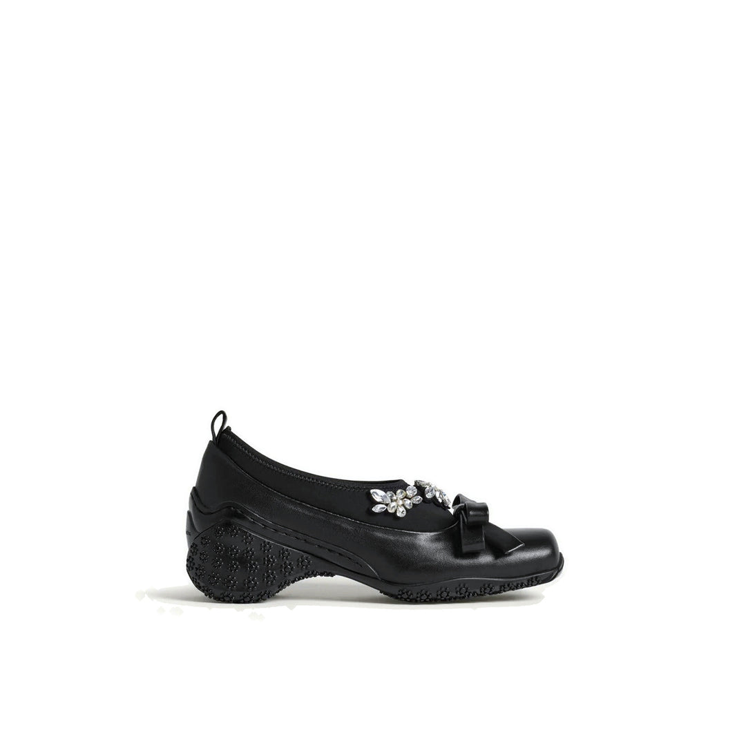 Simone Rocha black Bow Ballet Runner with a neoprene upper, crystal flower embellishment, a leather bow and a floral-studded sole, shown in side profile - packshot
