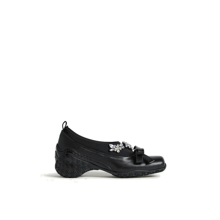 Simone Rocha black Bow Ballet Runner with a neoprene upper, crystal flower embellishment, a leather bow and a floral-studded sole, shown in side profile - packshot