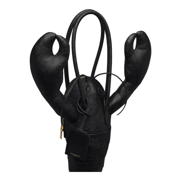 Thom Browne black pebble-grain leather lobster-shaped tote bag with raised claws, rolled handles and a luggage tag - packshot