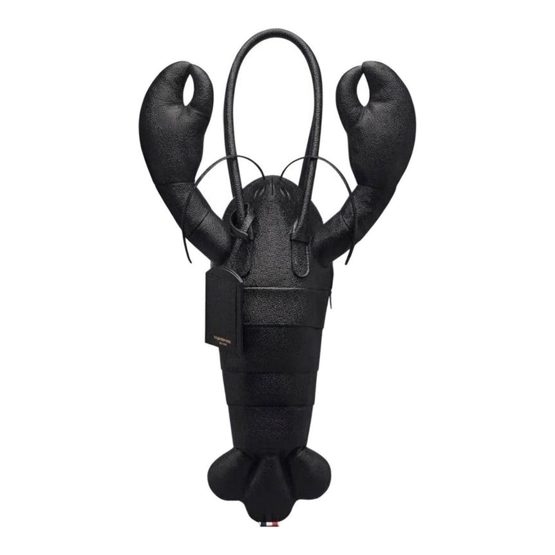 Thom Browne black pebble-grain leather lobster-shaped tote bag with raised claws, rolled handles and a luggage tag - packshot