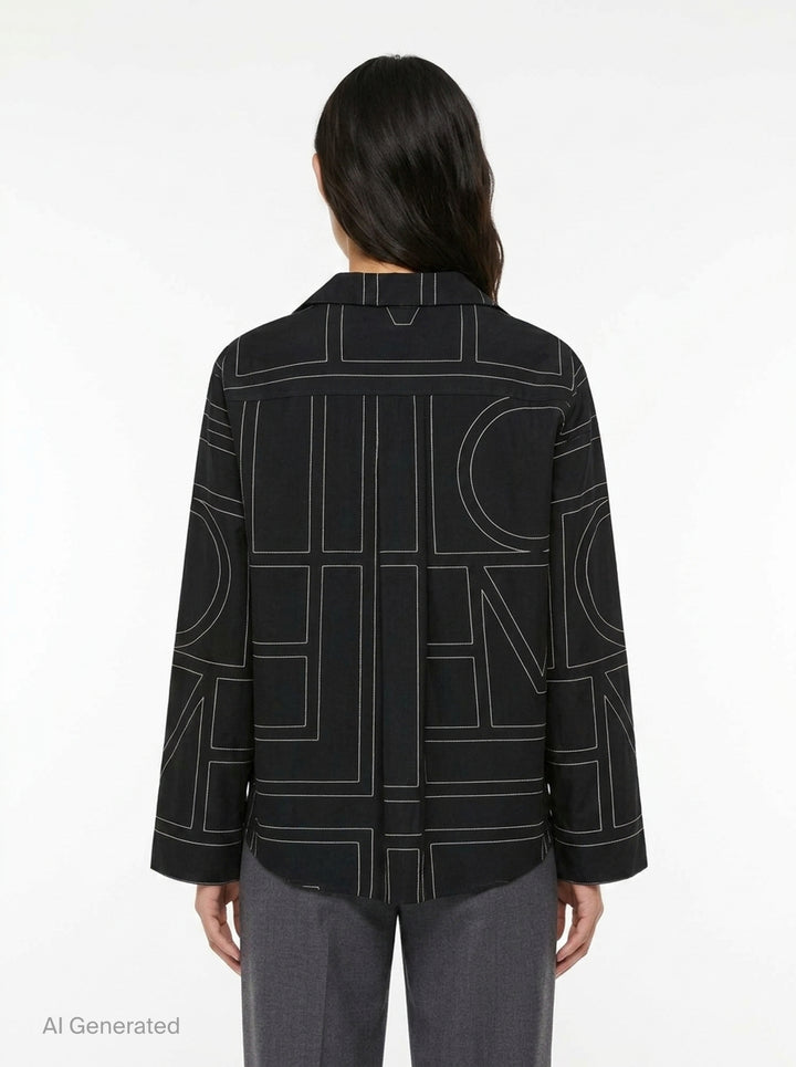 Totême Monogram Silk Pyjama Top in black, featuring all-over contrast-stitched monogram print, camp collar, partial button placket, and relaxed long-sleeve silhouette - back