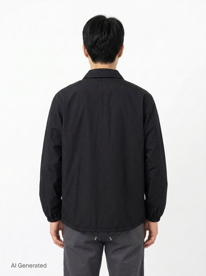 visvim Windfall Coach Jacket in black with embroidered Harmony script, snap-button front closure, and elasticated cuffs - back