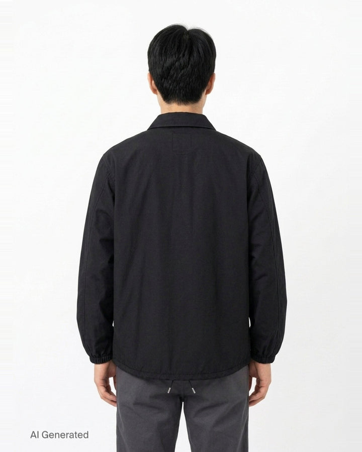 visvim Windfall Coach Jacket in black with embroidered Harmony script, snap-button front closure, and elasticated cuffs - back