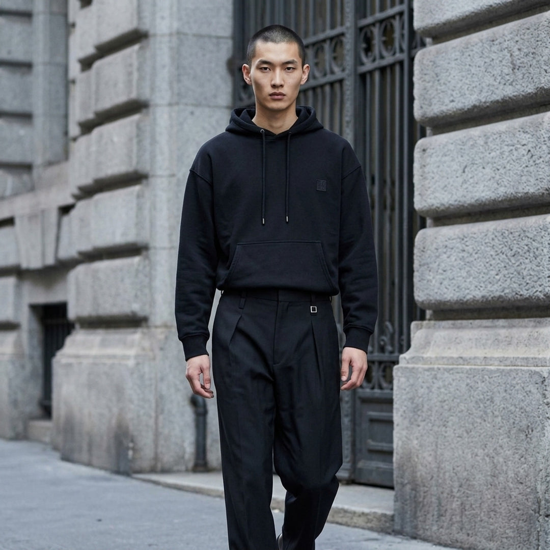 Wooyoungmi black pullover hoodie with drawstring hood, kangaroo pocket and tonal logo patch on the chest - lifestyle