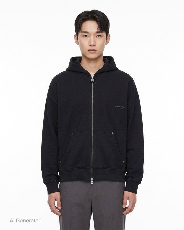 Black Wooyoungmi zip-up hoodie with padlock-style zip pull, stud-detailed kangaroo pockets and small gold logo on the chest - front